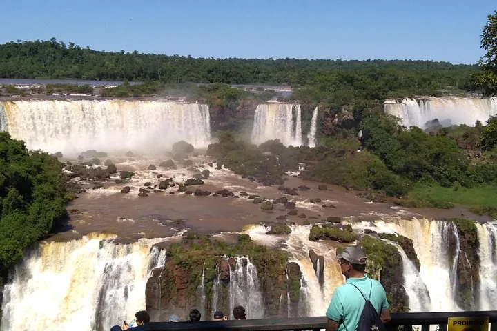 Wide perspective of majestic waterfalls rushing over tiered rocky cliffs.